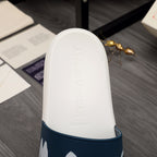 White slide sandal footbed with embossed logo and navy strap