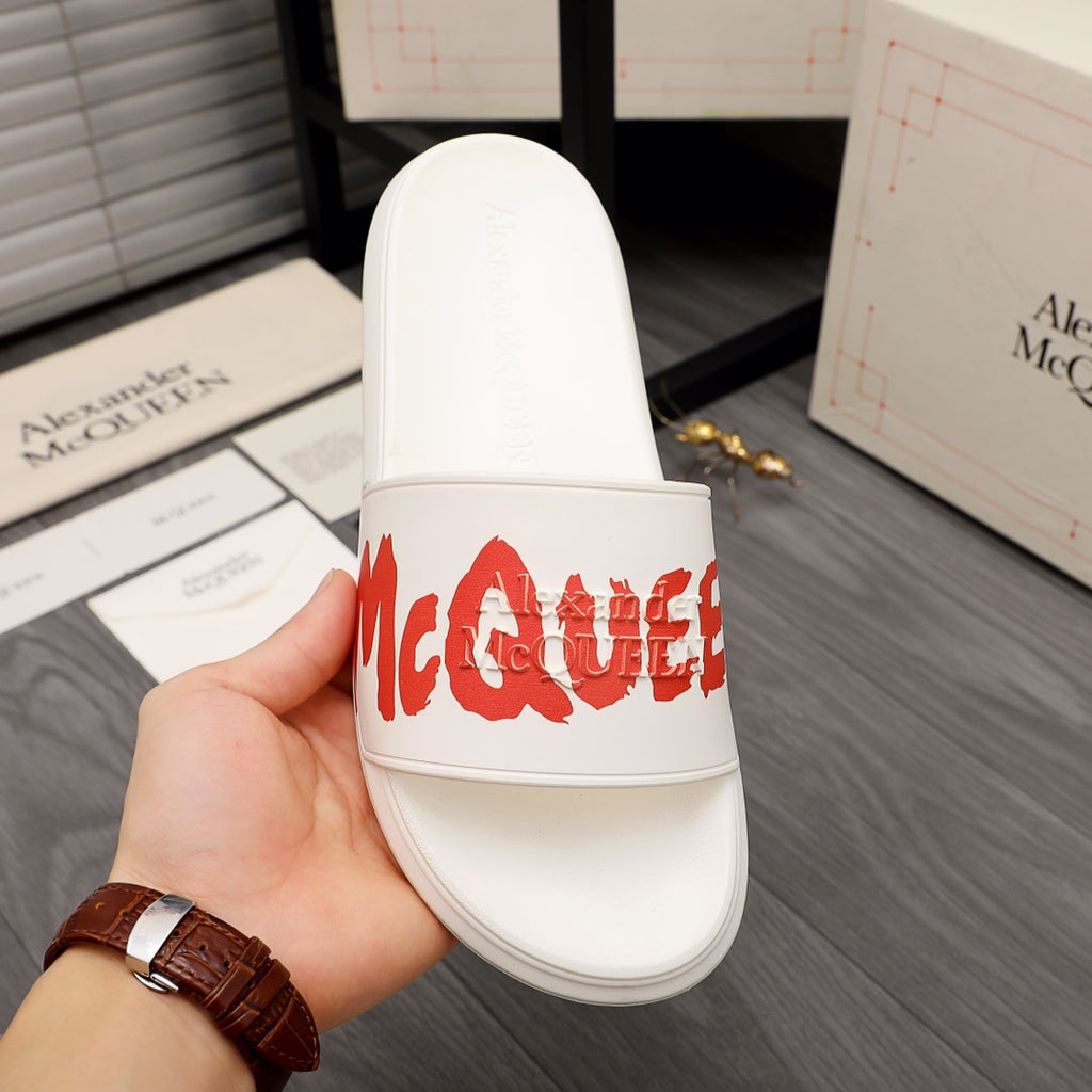White Alexander McQueen slide sandal with red logo on front strap