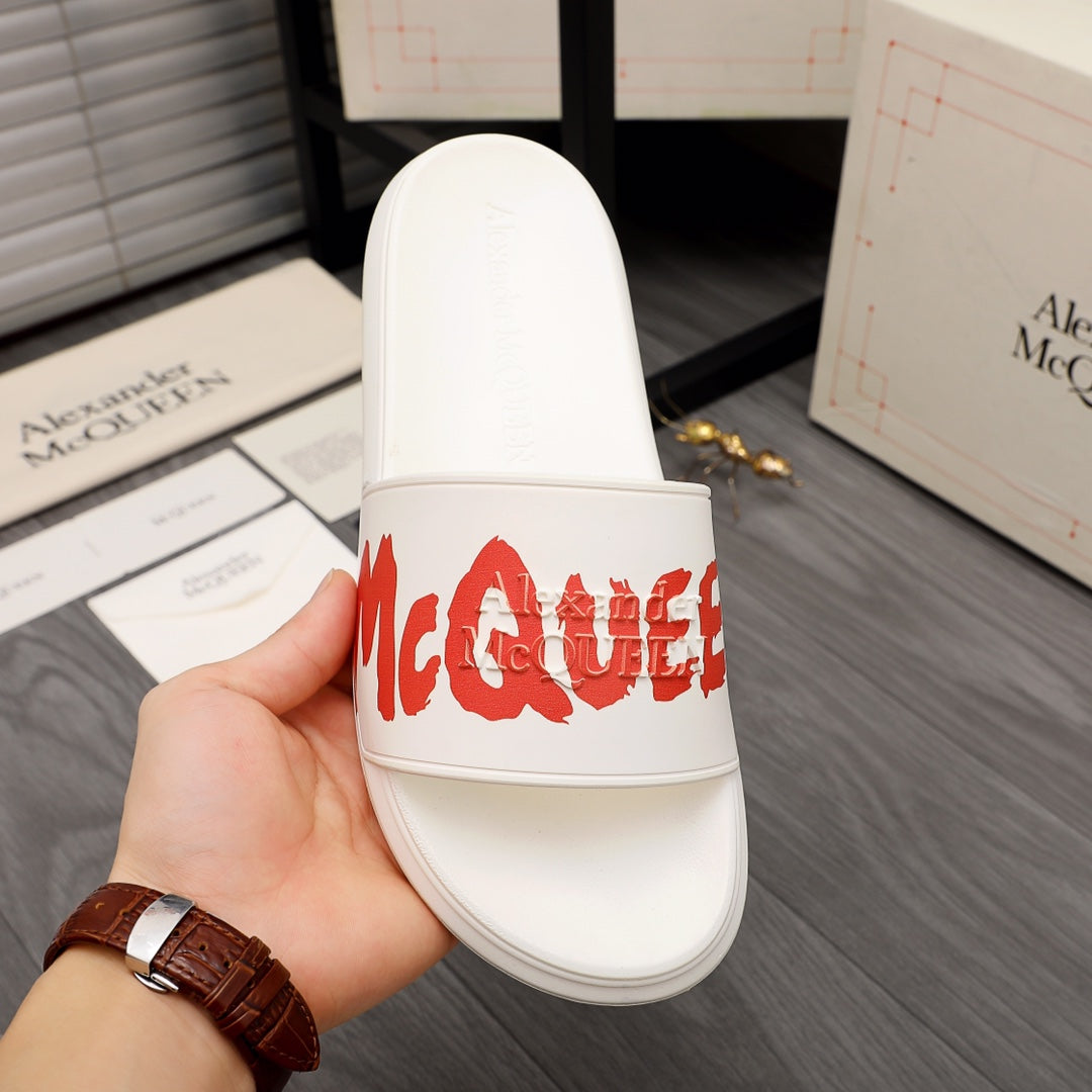 White Alexander McQueen slide sandal with red logo on front strap