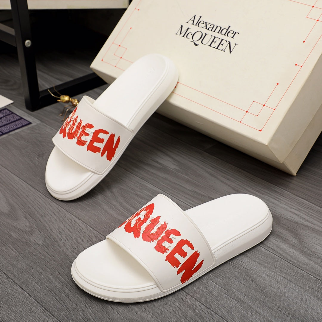 White Alexander McQueen slide sandals with red logo strap