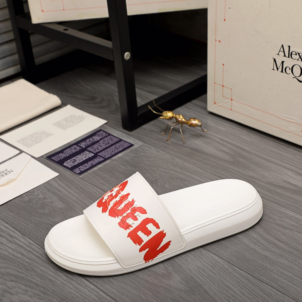 White slide sandal with red logo lettering on strap