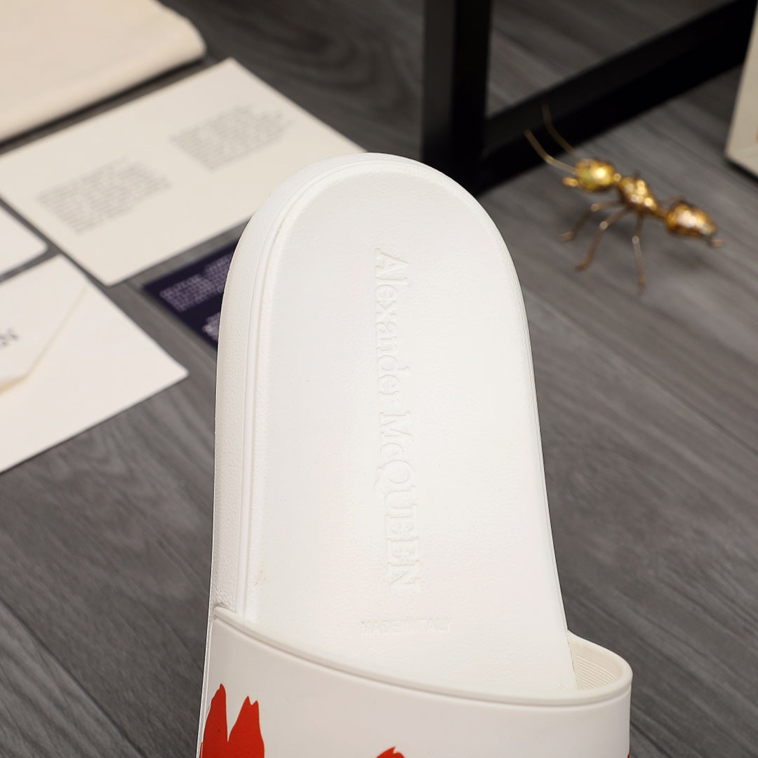 White slide sandal showing embossed text on the inner footbed