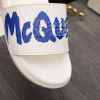 Alexander McQueen white slide sandal with blue MCQ logo on upper