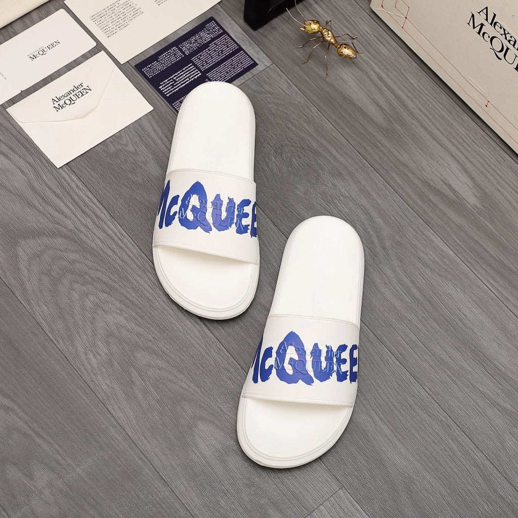 Alexander McQueen white slide sandals pair with blue logo on straps