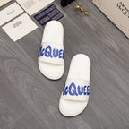 Alexander McQueen white slide sandals pair with blue logo on straps