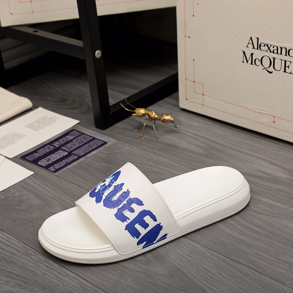 Alexander McQueen white slide sandals, side view with blue logo strap