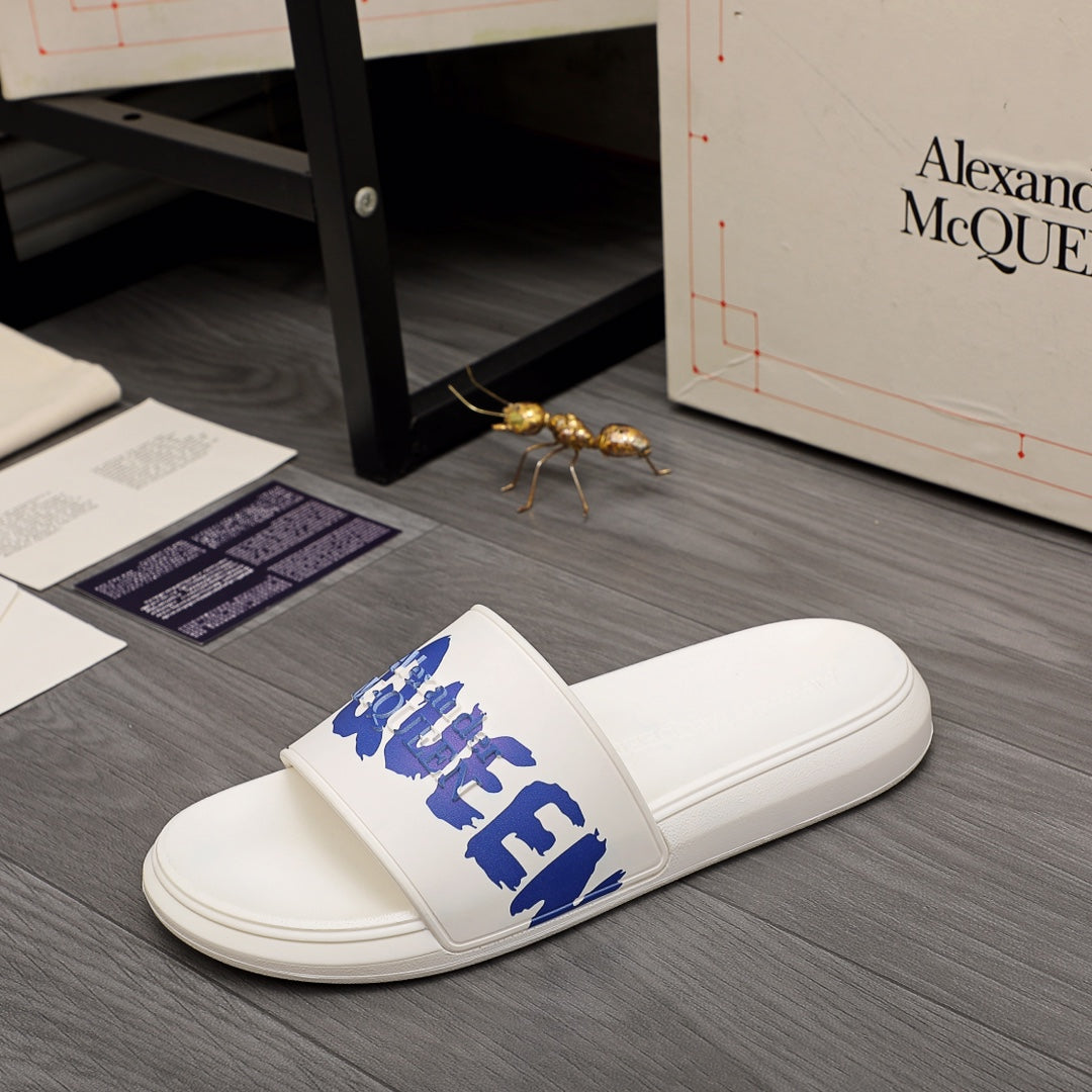 Alexander McQueen white slide sandals, side view with blue logo strap
