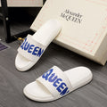 Alexander McQueen white slide sandals with blue logo strap