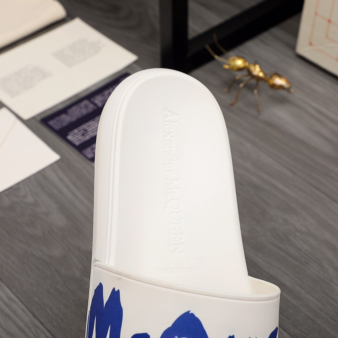 Alexander McQueen white slide sandal with blue logo strap and molded footbed