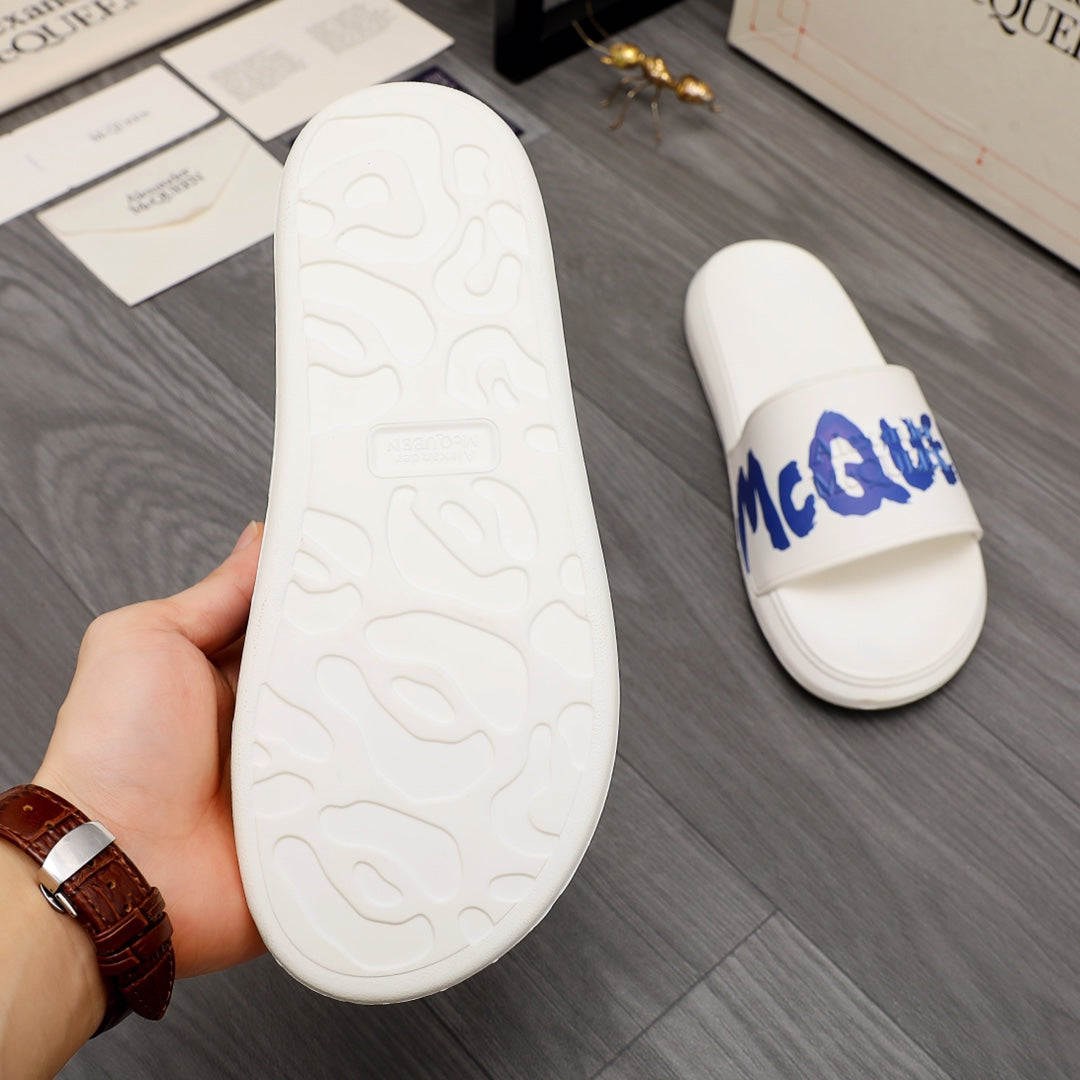 Alexander McQueen white slide sandals showing textured outsole underside