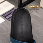Black slide sandal footbed with embossed Alexander McQueen branding