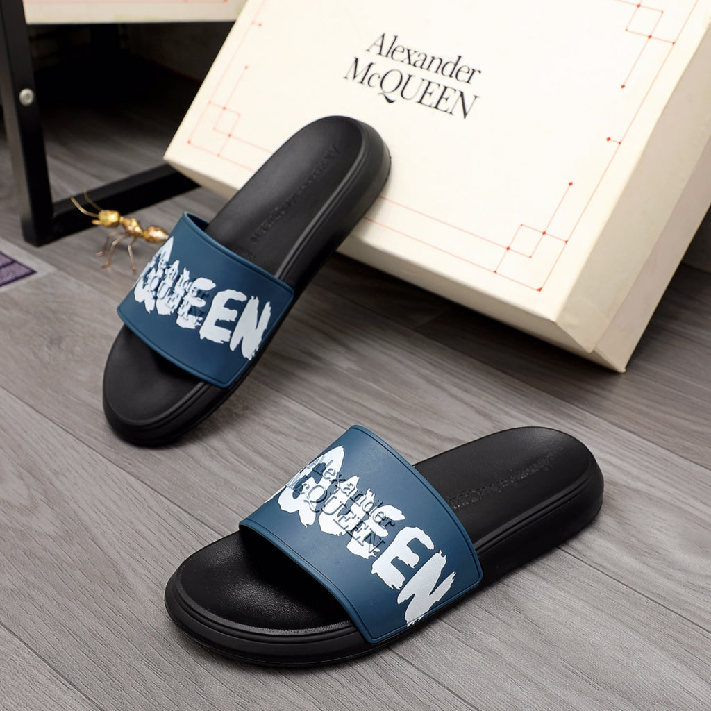 Black slide sandals with blue strap and white logo graphic