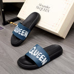 Black slide sandals with blue strap and white logo graphic