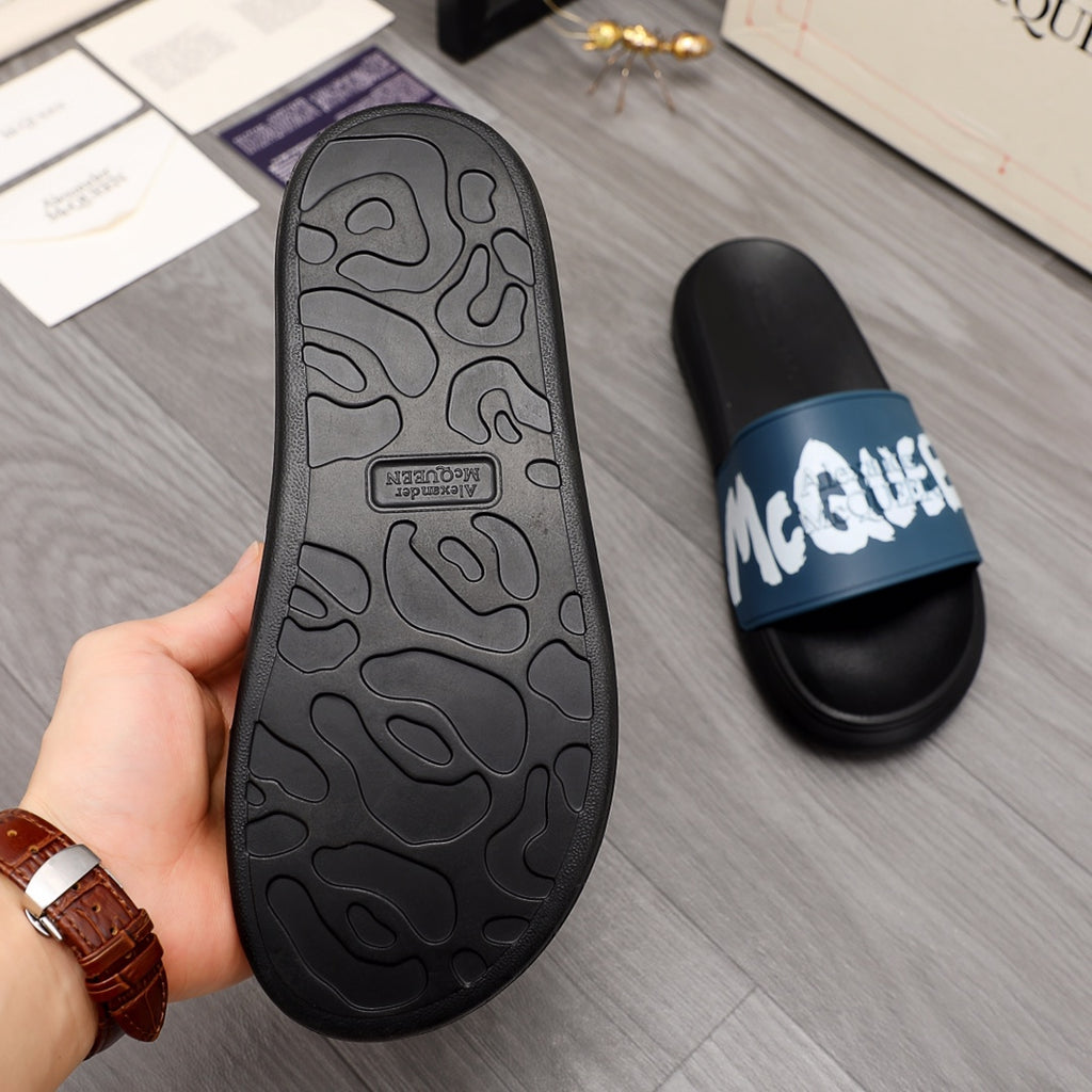 Black slide sandal outsole with textured tread pattern, side view