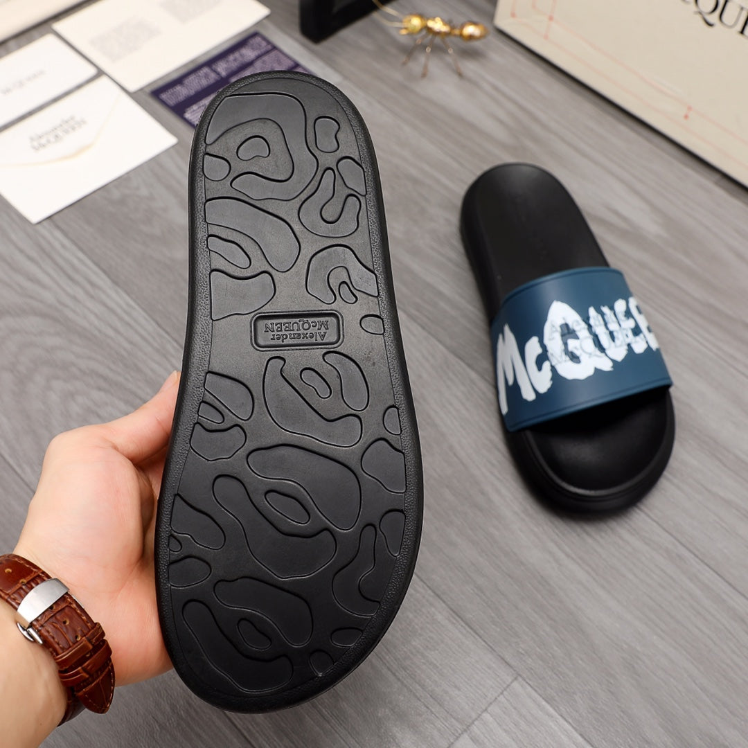 Black slide sandal outsole with textured tread pattern, side view