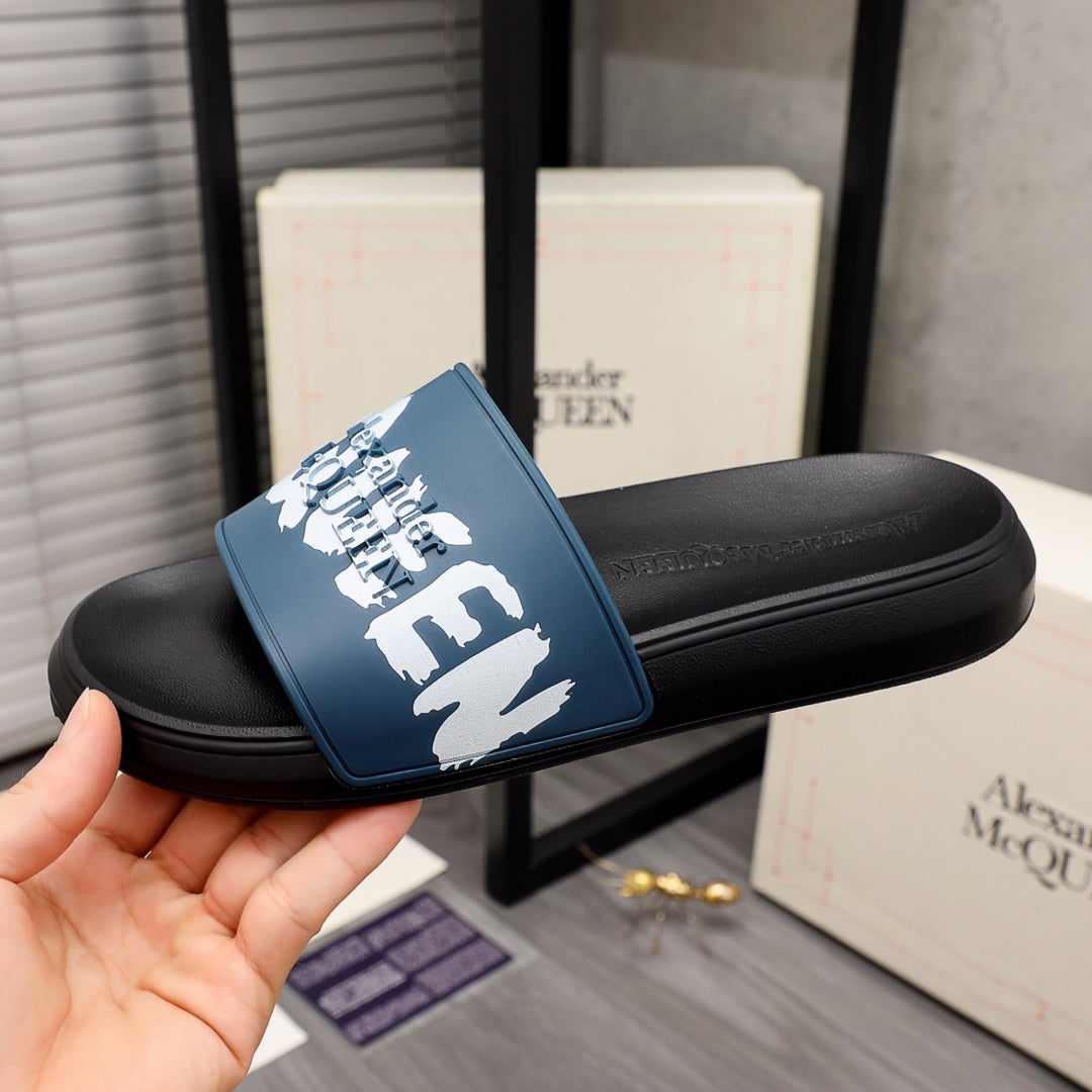 Black slide sandals with blue logo strap and white elephant graphic