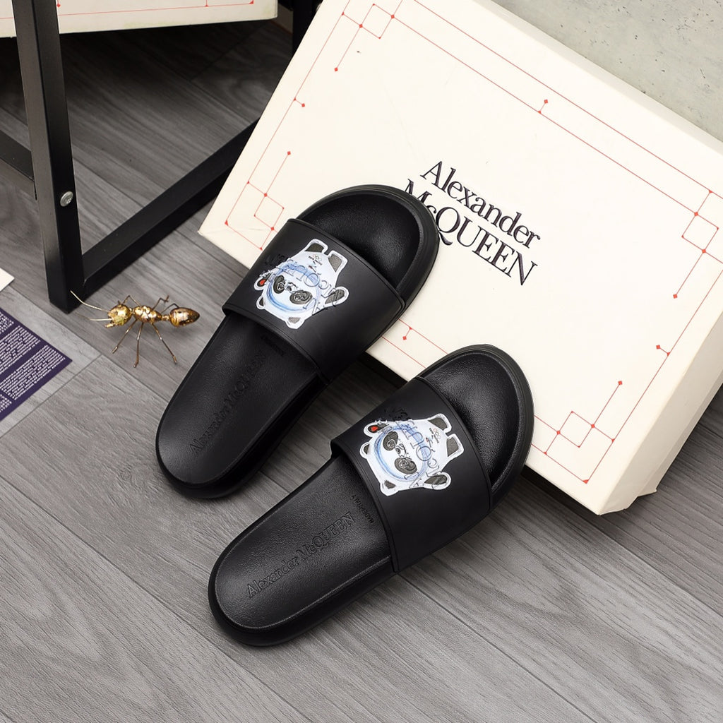 Black slide sandals with panda emblem on front strap