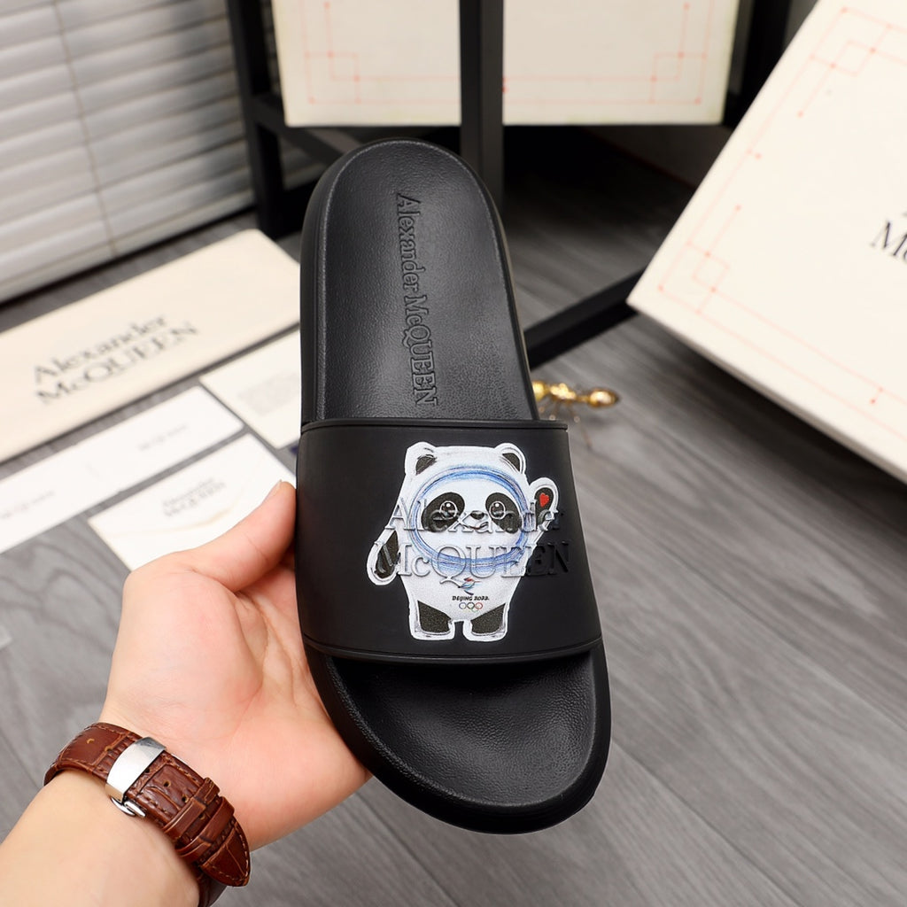 Black slide sandal with panda emblem on front strap