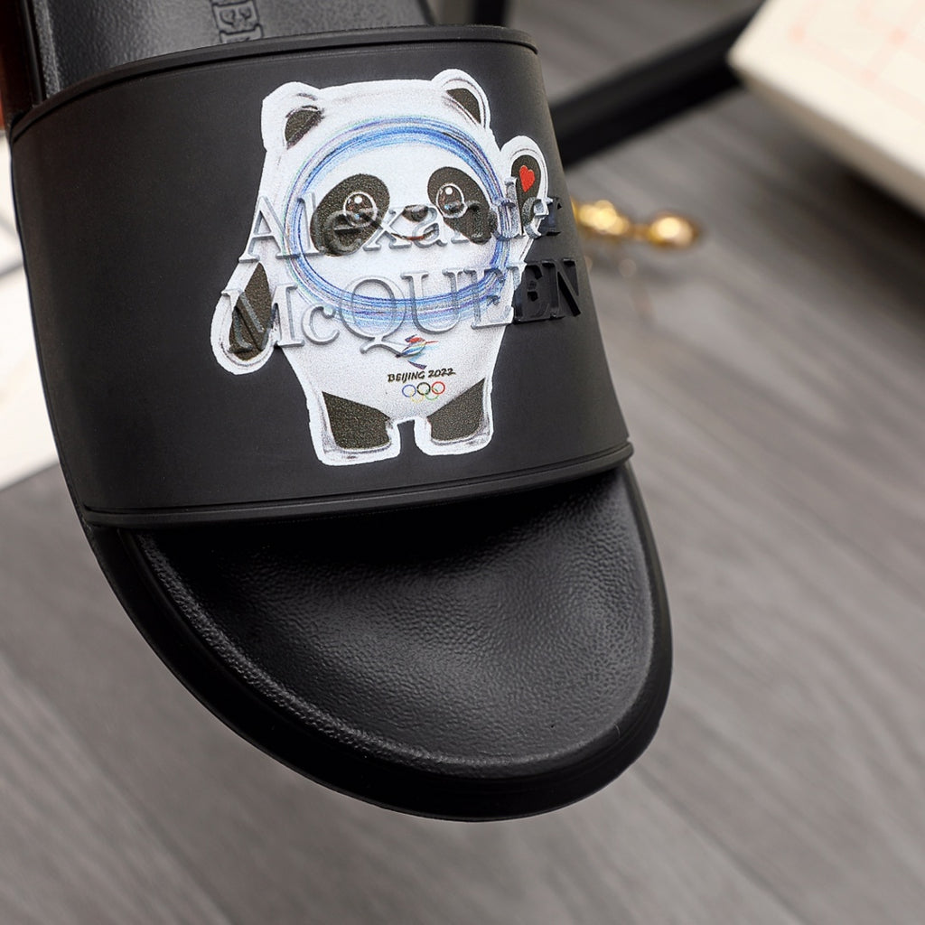 Black slide sandal with large panda face graphic on the strap