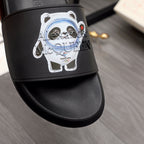 Black slide sandal with large panda face graphic on the strap