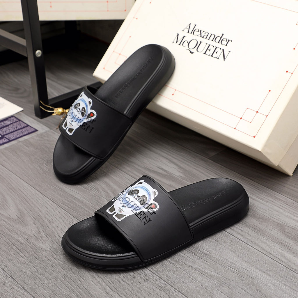 Black slide sandals with wide strap and panda logo patch