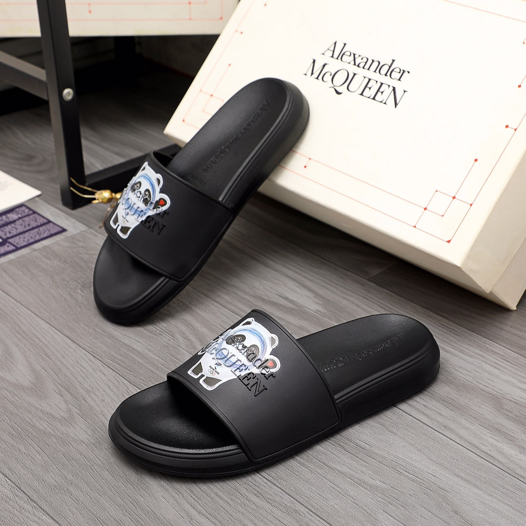 Black slide sandals with wide strap and panda logo patch