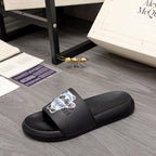 Black slide sandals with wide strap and colorful panda graphic