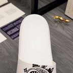 White slide sandal heel and strap edge with embossed brand lettering