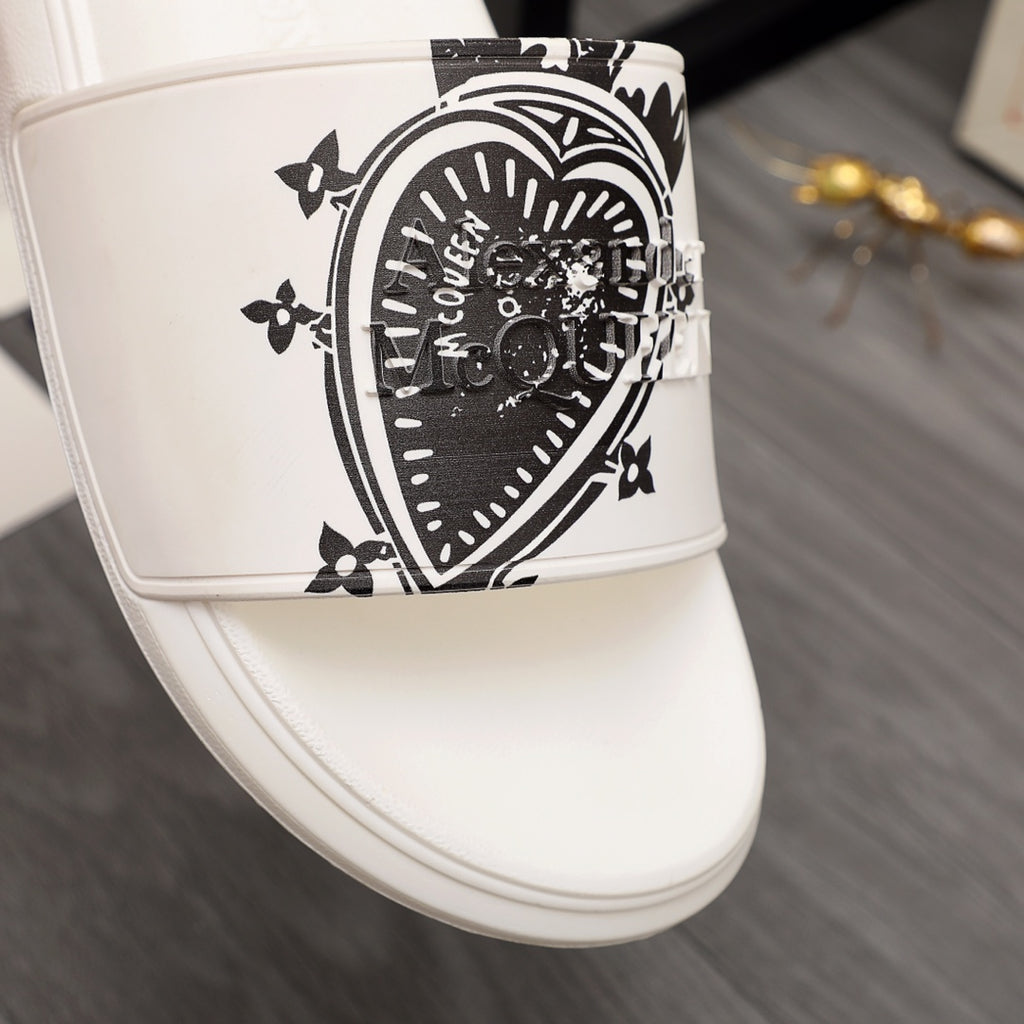 Close-up of white slide sandal strap with large black emblem graphic