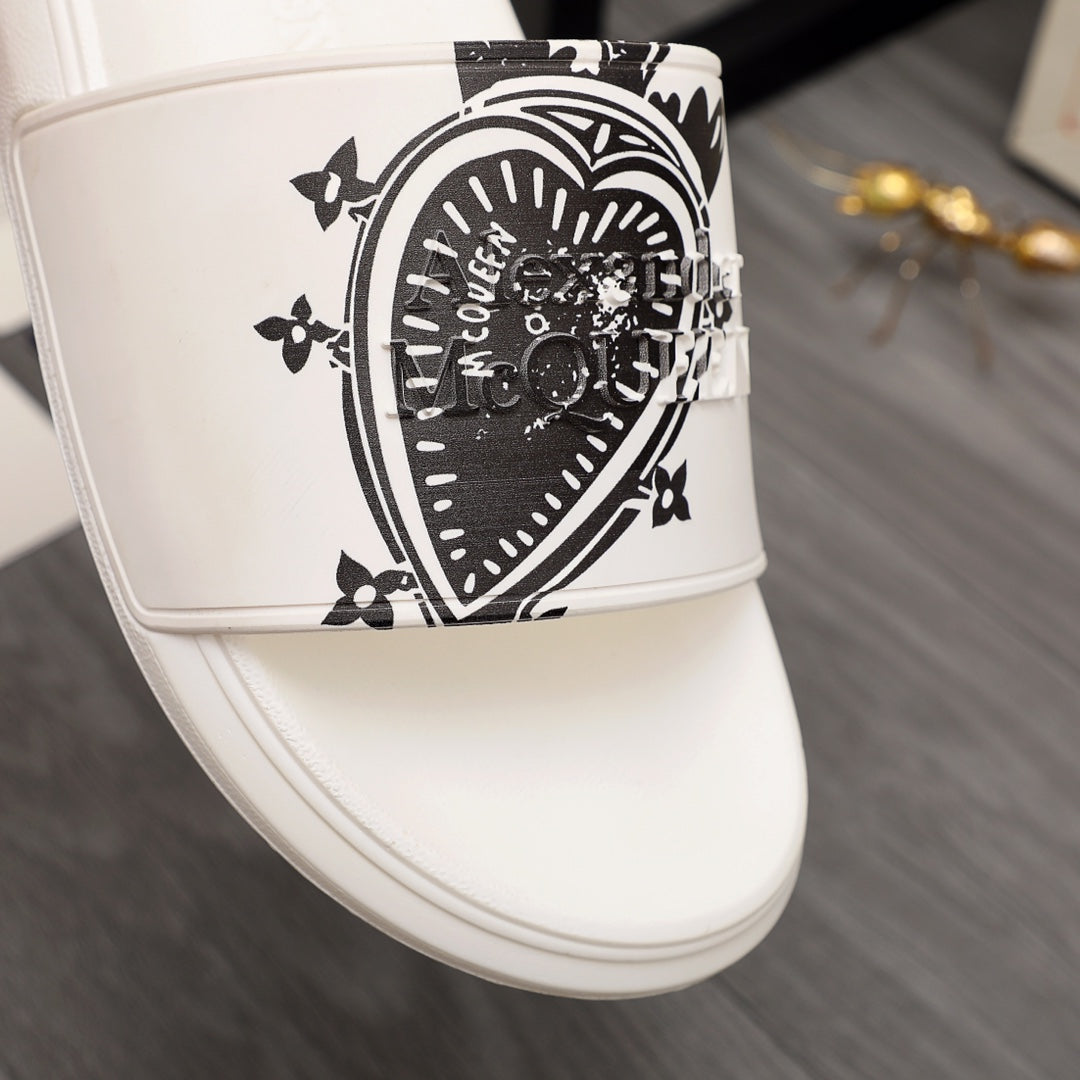 Close-up of white slide sandal strap with large black emblem graphic