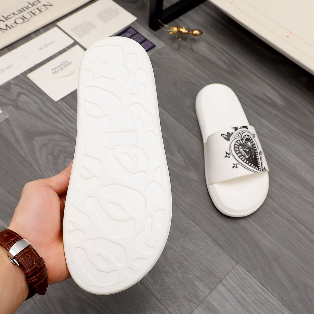White slide sandal outsole with molded tread pattern, shown in hand