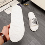 White slide sandal outsole with molded tread pattern, shown in hand