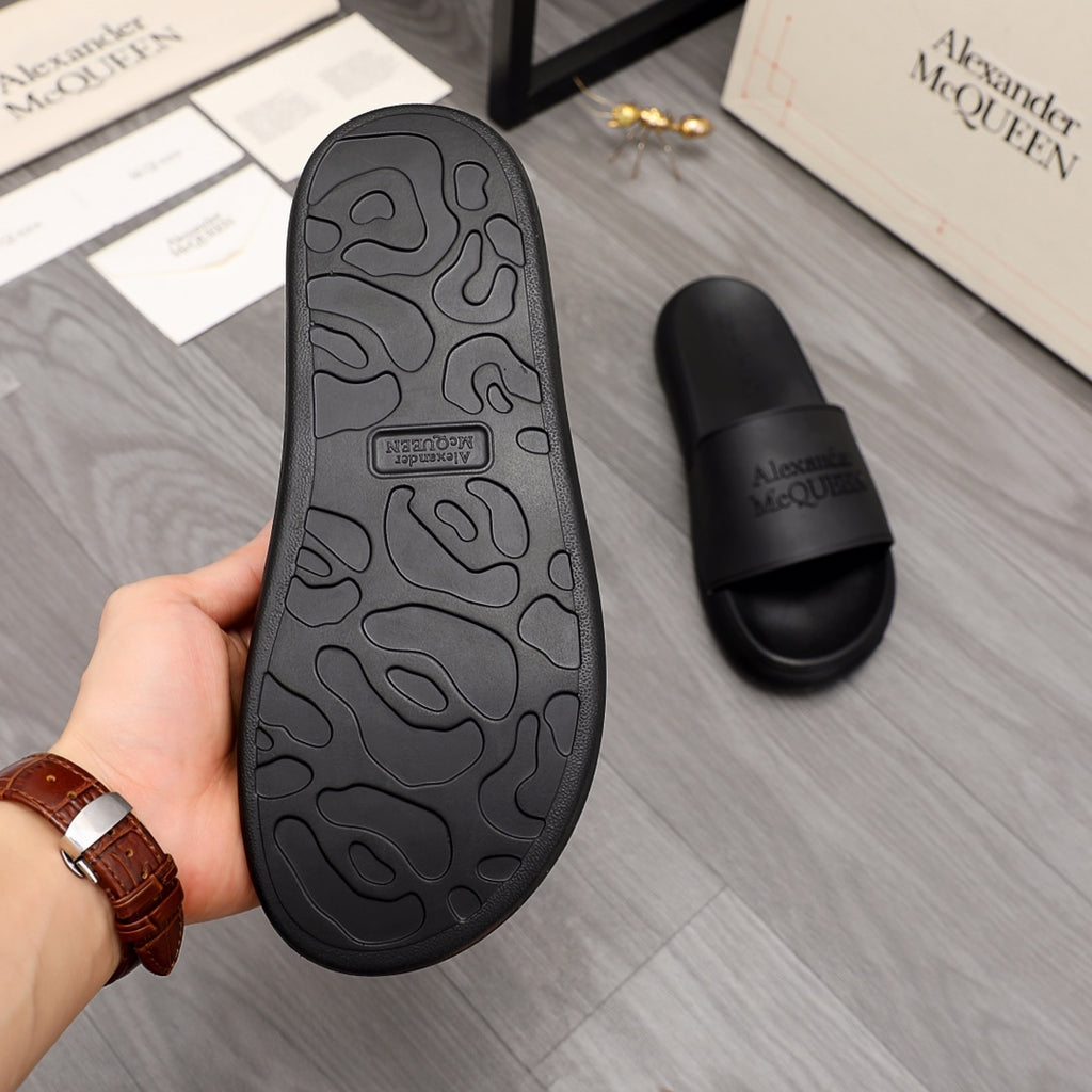 Black rubber slide sandal outsole with textured pattern, rear view