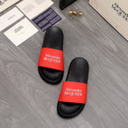 Pair of black slide sandals with red Alexander McQUEEN logo straps