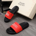 Black slide sandals with red Alexander McQUEEN strap and cushioned footbed