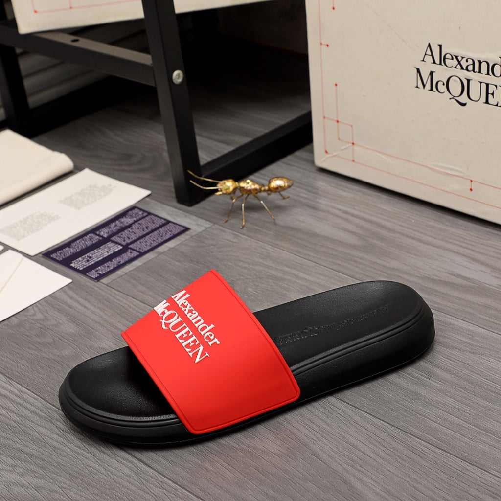 Black slide sandal with bright red Alexander McQUEEN logo strap, rounded toe