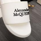 White slide sandal close-up of Alexander McQUEEN logo on strap