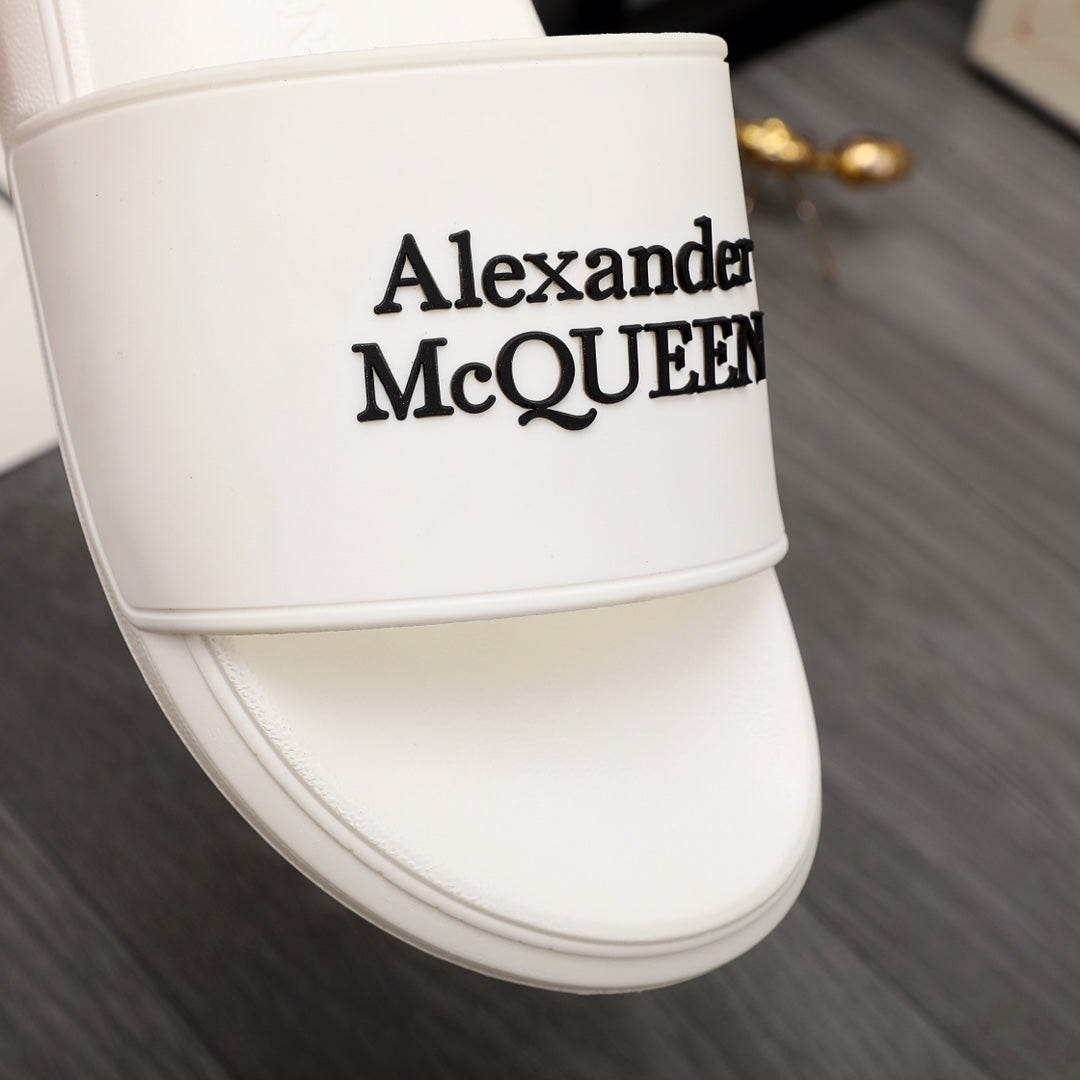 White slide sandal close-up of Alexander McQUEEN logo on strap