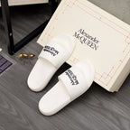 White slide sandals pair with Alexander McQUEEN logo on footbeds
