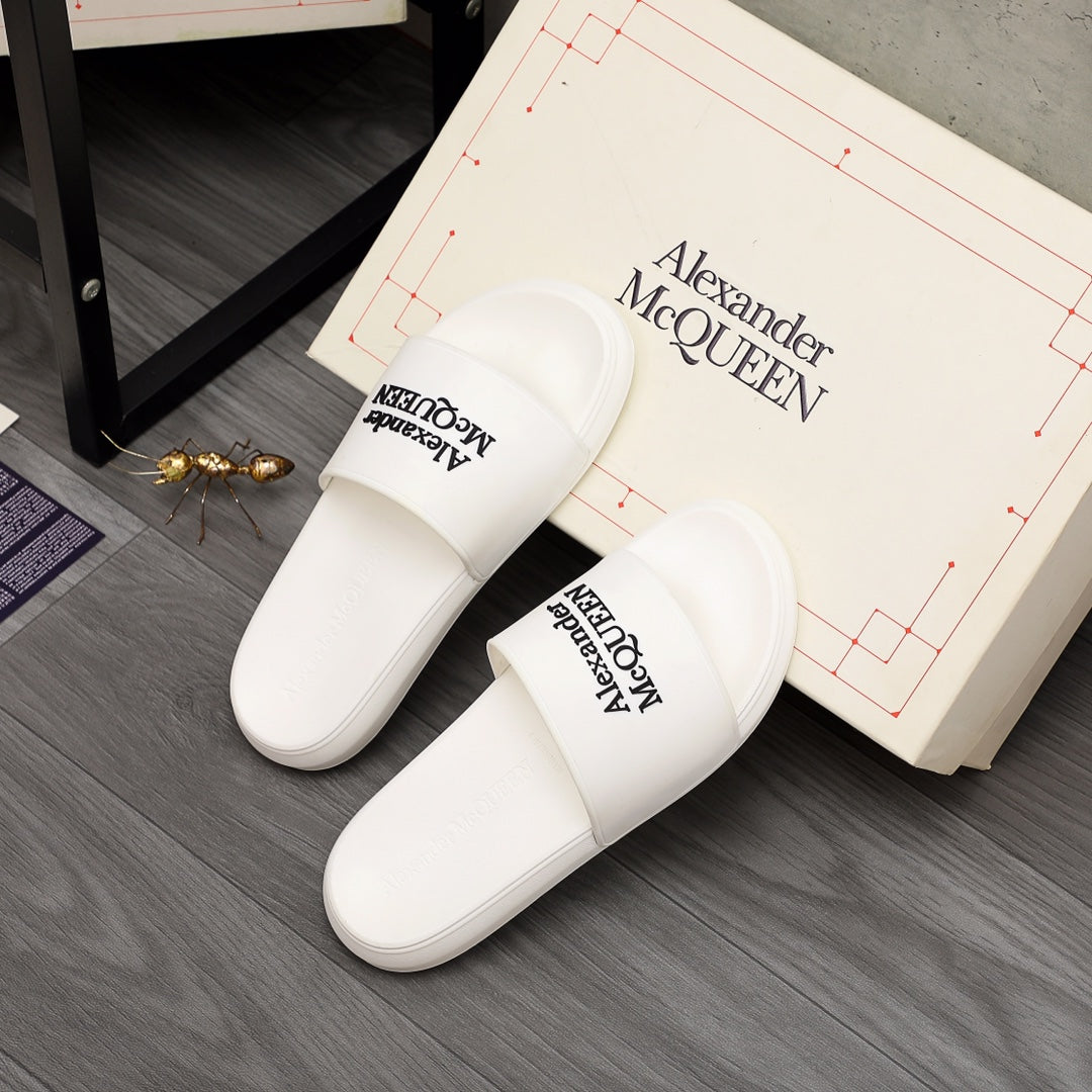 White slide sandals pair with Alexander McQUEEN logo on footbeds