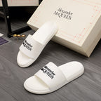 White slide sandal with wide logo strap, Alexander McQUEEN branding