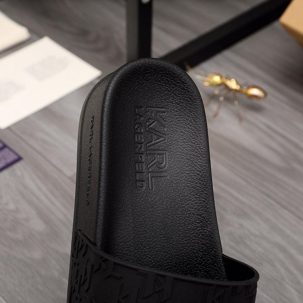 Black slide sandal footbed with debossed Alexander McQueen logo and textured upper