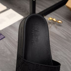 Black slide sandal footbed with debossed Alexander McQueen logo and textured upper