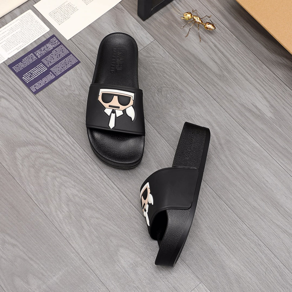 Black slide sandals showing footbed and side strap with graphic emblem
