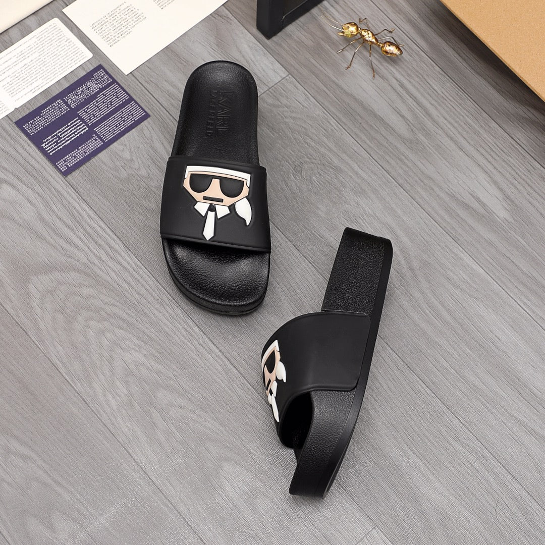 Black slide sandals showing footbed and side strap with graphic emblem
