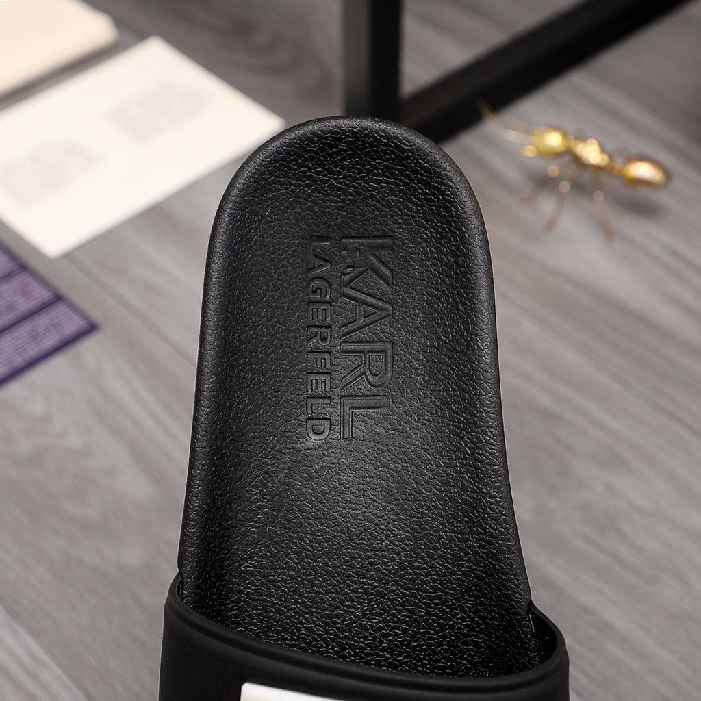 Black slide sandal footbed with embossed Alexander McQueen lettering