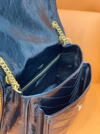 YSL Saint Laurent bag interior view, dark blue lining with gold chain trim