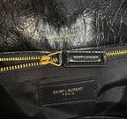 YSL Saint Laurent bag label, gold zipper pull and SAINT LAURENT PARIS text