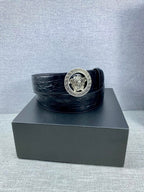 Black embossed leather belt with round Versace medallion buckle and wide strap