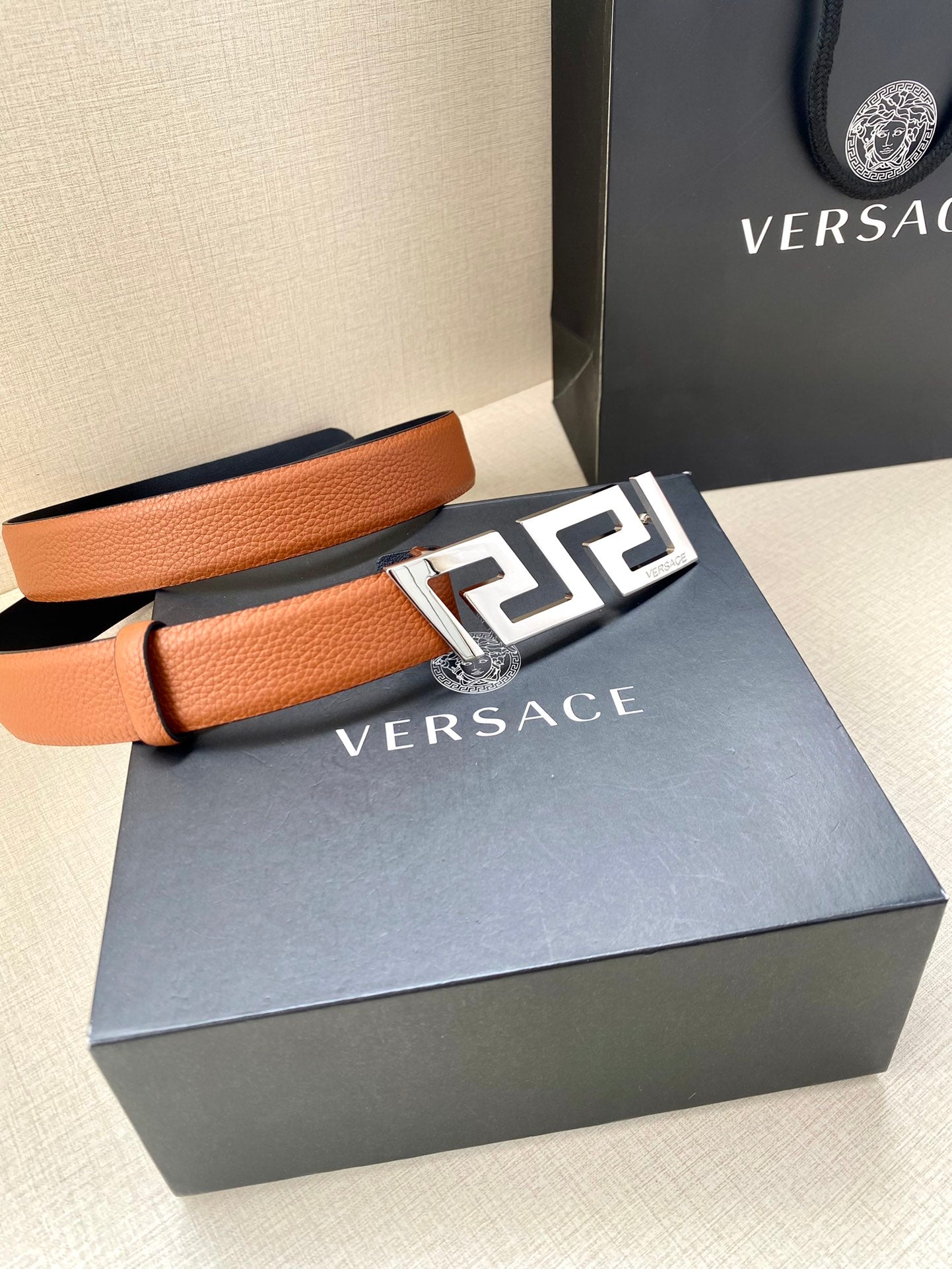 Versace belt with tan leather strap and gold logo buckle